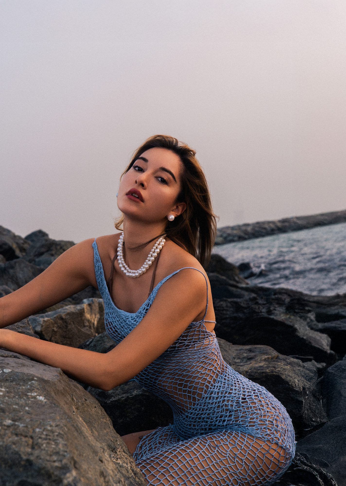 Portrait study of a model on the rocks by the sea